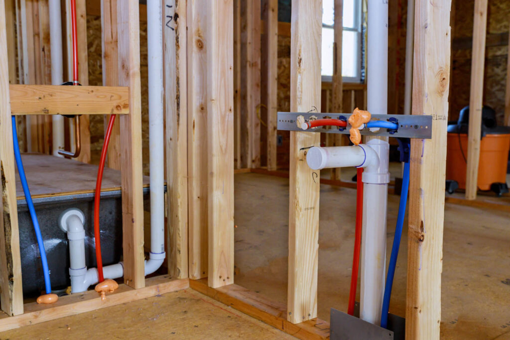 Under construction new home PVC waste water system rough plumbing drainage pipe and fitting complete